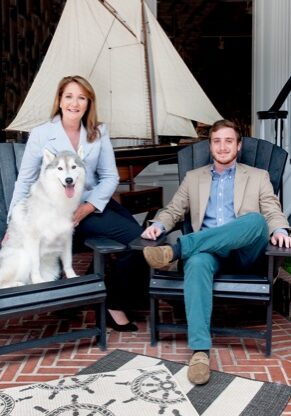 photo of a man and a woman and a dog sitting on chairs